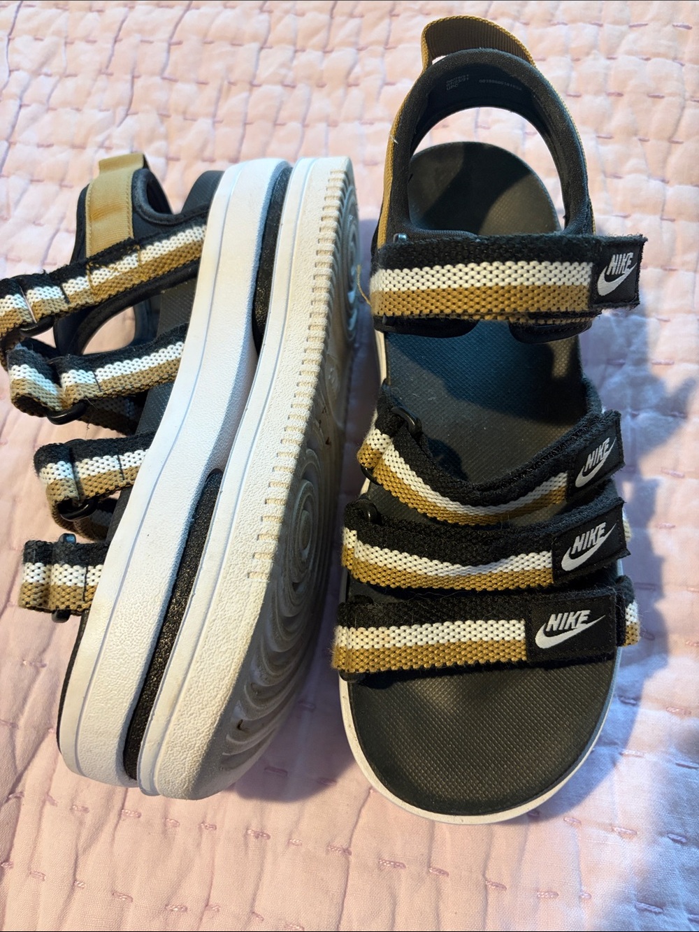 Nike women’s black & Gold Stripe Sandals